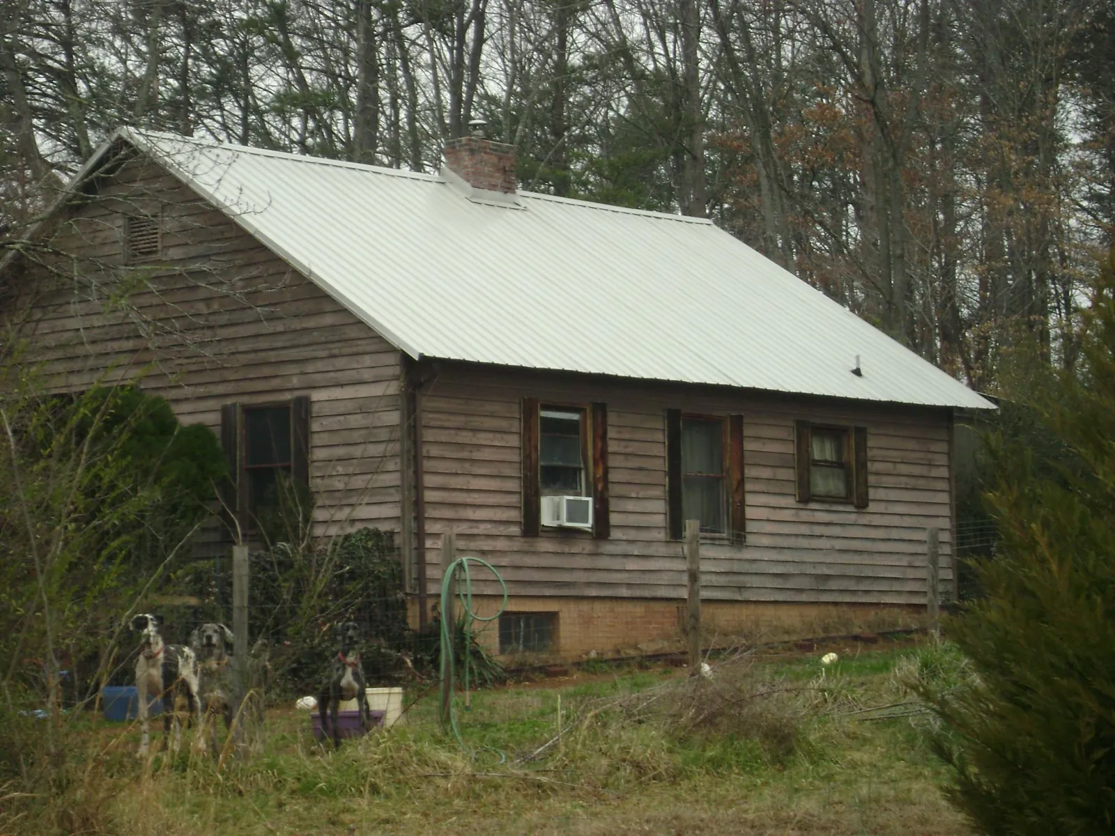 White metal roof on an old wood sided farmhouse, from a Metal Roof Installation job in Rougemont